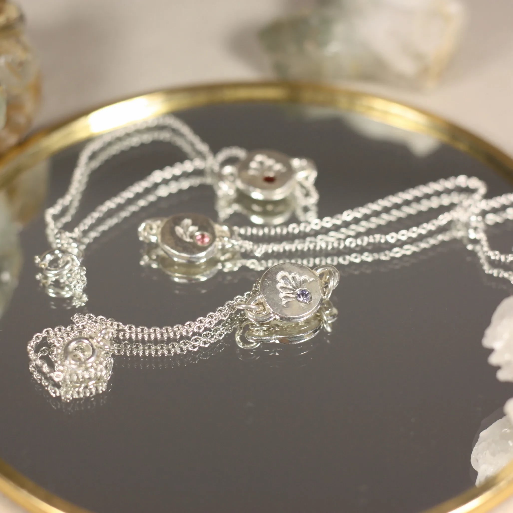 L'Écho - Un bracelet en argent avec une médaille ornée d'une pierre fine